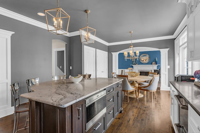 8 Jacob Ln, Killingworth, CT 06419 - kitchen with appliances with stainless steel finishes, arched walkways, dark wood-style floors, a chandelier, and hanging light fixtures