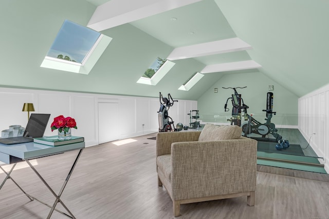 8 Jacob Ln, Killingworth, CT 06419 - living area featuring a skylight, light wood-style floors, a decorative wall, and vaulted ceiling