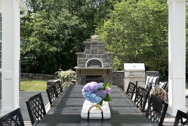 8 Jacob Ln, Killingworth, CT 06419 - wooden terrace with an outdoor stone fireplace and an outdoor kitchen