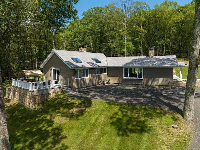 85 Good Hill Rd, Roxbury, CT 06783 - view of front of house with a chimney, a wooden deck, and a front lawn