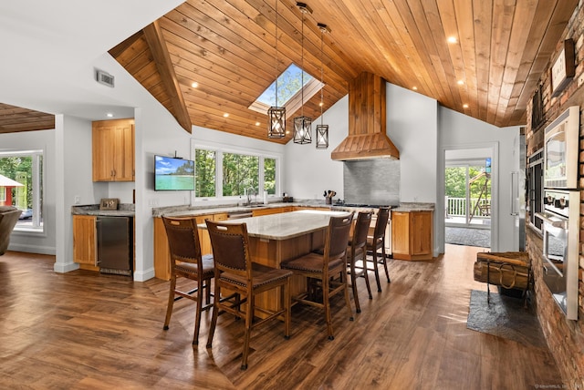 85 Good Hill Rd, Roxbury, CT 06783 - kitchen featuring a skylight, wood ceiling, fridge, dark wood finished floors, and a center island