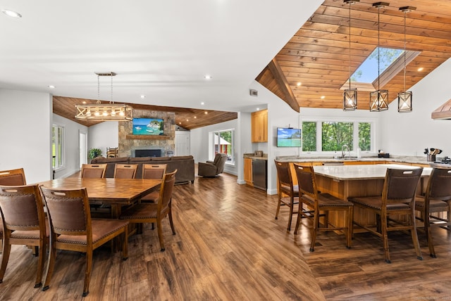 85 Good Hill Rd, Roxbury, CT 06783 - dining area featuring lofted ceiling, a skylight, dark wood-type flooring, a large fireplace, and recessed lighting