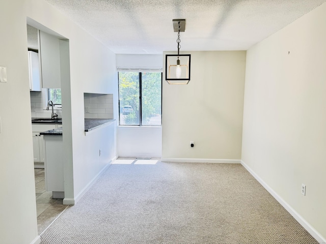 93 Trolley Crossing Ln Unit 93, Middletown, CT 06457 - unfurnished dining area featuring light carpet and a textured ceiling