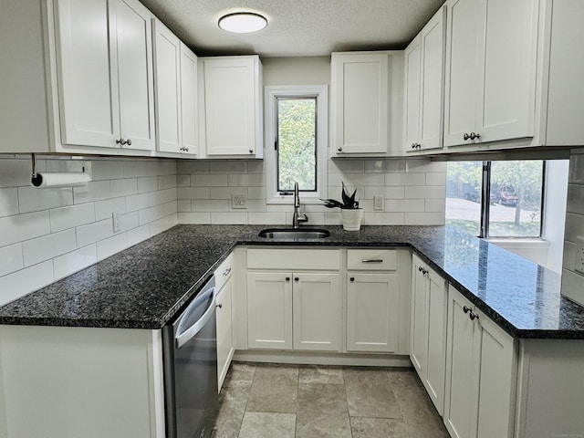 93 Trolley Crossing Ln Unit 93, Middletown, CT 06457 - kitchen featuring stainless steel dishwasher, a textured ceiling, backsplash, and white cabinets