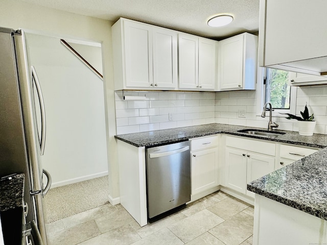 93 Trolley Crossing Ln Unit 93, Middletown, CT 06457 - kitchen with appliances with stainless steel finishes, dark stone countertops, decorative backsplash, white cabinets, and a textured ceiling