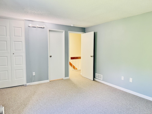 93 Trolley Crossing Ln Unit 93, Middletown, CT 06457 - unfurnished bedroom featuring a closet, carpet flooring, and a textured ceiling