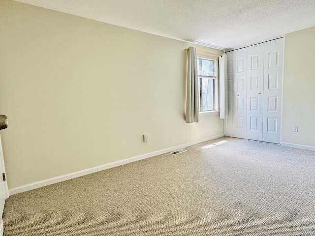 93 Trolley Crossing Ln Unit 93, Middletown, CT 06457 - unfurnished bedroom featuring carpet flooring, a closet, and a textured ceiling
