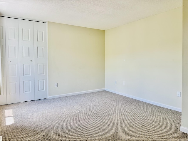 93 Trolley Crossing Ln Unit 93, Middletown, CT 06457 - unfurnished bedroom featuring carpet flooring, a closet, and a textured ceiling