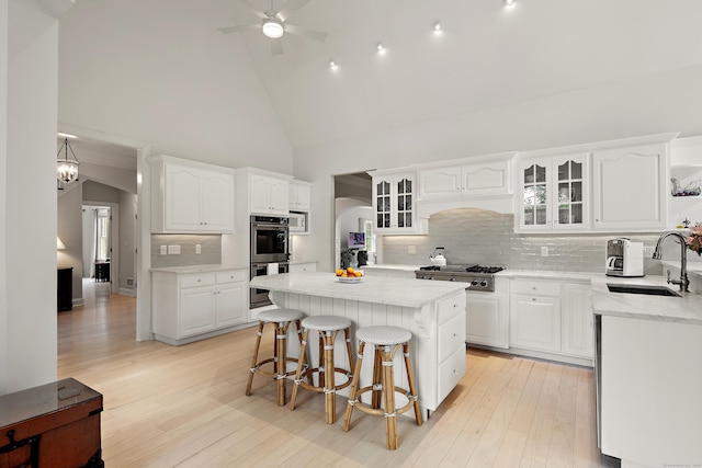 7 Merlins Ln, Newtown, CT 06470 - kitchen with appliances with stainless steel finishes, high vaulted ceiling, white cabinets, and arched walkways