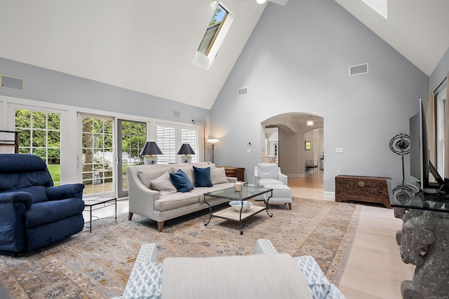 7 Merlins Ln, Newtown, CT 06470 - living room with high vaulted ceiling, arched walkways, wood finished floors, and a skylight