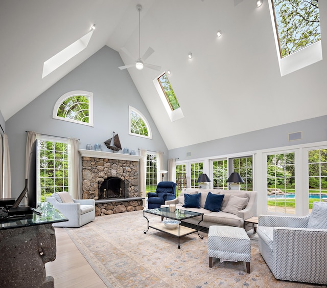 7 Merlins Ln, Newtown, CT 06470 - living room with a skylight, high vaulted ceiling, a ceiling fan, a fireplace, and wood finished floors