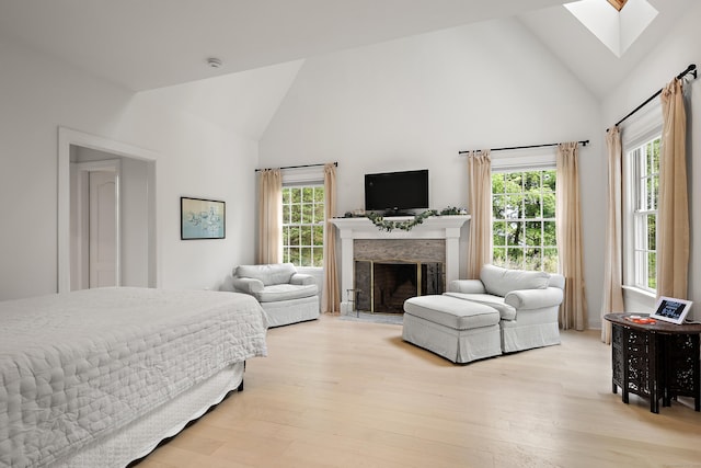 7 Merlins Ln, Newtown, CT 06470 - bedroom featuring high vaulted ceiling, a skylight, multiple windows, light wood-style floors, and a fireplace