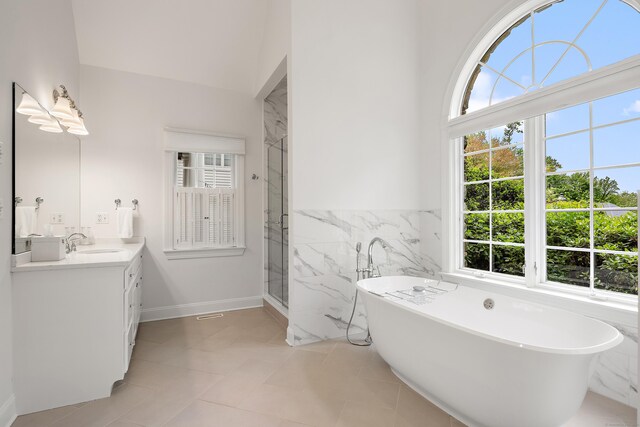 7 Merlins Ln, Newtown, CT 06470 - bathroom featuring healthy amount of natural light, vanity, a soaking tub, tile walls, and a marble finish shower
