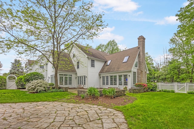 7 Merlins Ln, Newtown, CT 06470 - back of house with a gate, a patio, a chimney, and roof with shingles