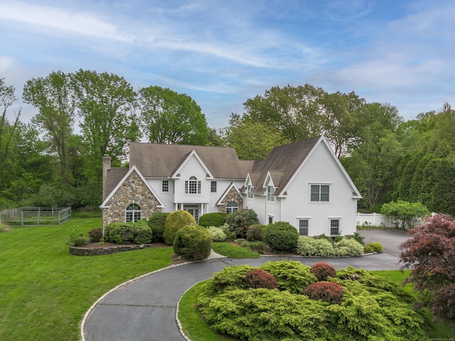 7 Merlins Ln, Newtown, CT 06470 - view of front of home with a chimney, curved driveway, and stone siding