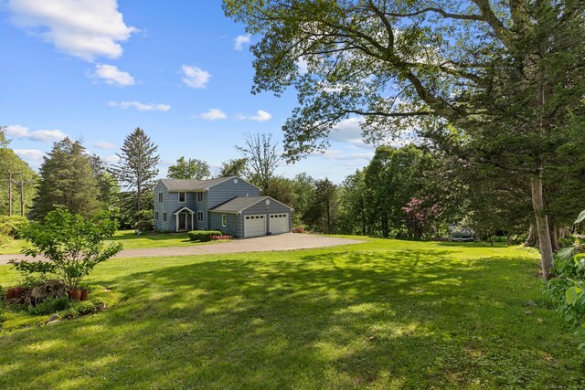 403 Bethmour Rd, Bethany, CT 06524 - view of grassy yard with a garage and concrete driveway