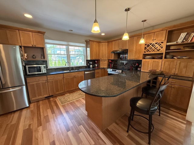 5 Lees Ct, Stonington, CT 06378 - kitchen featuring stainless steel appliances, open shelves, under cabinet range hood, decorative backsplash, and light wood-style flooring