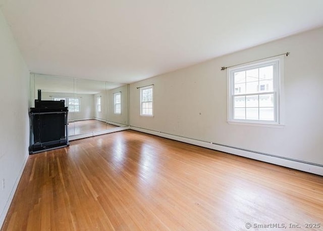 2 Rolf Dr, Danbury, CT 06810 - unfurnished living room with wood finished floors and a baseboard heating unit