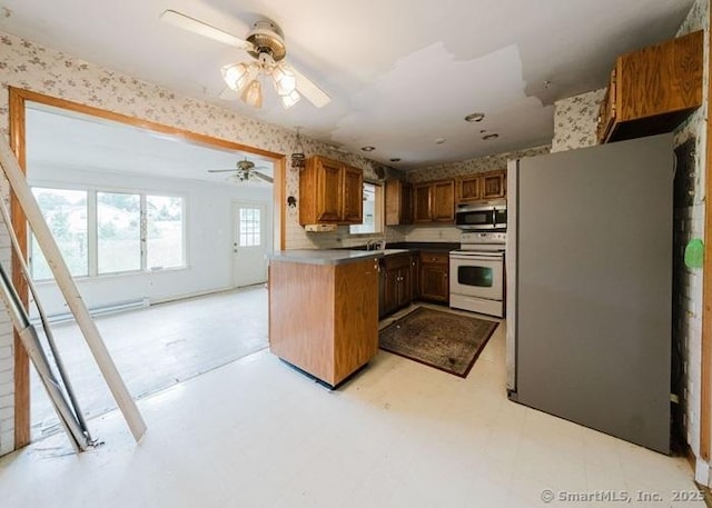 2 Rolf Dr, Danbury, CT 06810 - kitchen featuring white range with electric cooktop, stainless steel microwave, light floors, a ceiling fan, and brown cabinetry