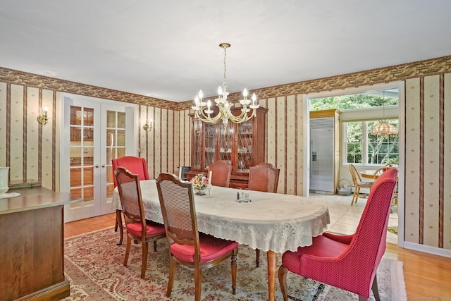 6 Robert Frost Dr, Shelton, CT 06484 - dining space featuring wallpapered walls, a chandelier, french doors, and light wood-type flooring