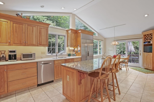 6 Robert Frost Dr, Shelton, CT 06484 - kitchen featuring stainless steel appliances, light tile patterned flooring, healthy amount of natural light, a breakfast bar, and recessed lighting
