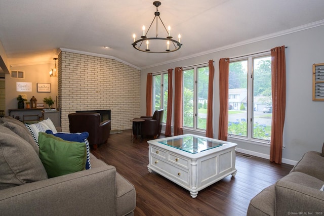66 Del Prado Dr, Bristol, CT 06010 - living room featuring ornamental molding, a chandelier, vaulted ceiling, a brick fireplace, and dark wood-style flooring