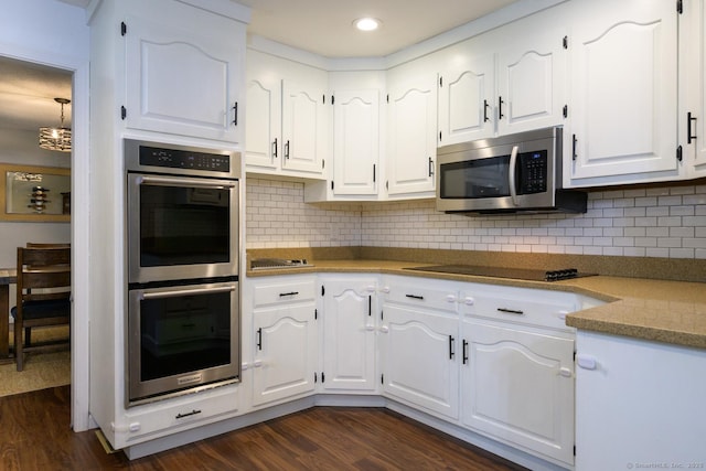 66 Del Prado Dr, Bristol, CT 06010 - kitchen with stainless steel appliances, dark wood finished floors, white cabinetry, recessed lighting, and decorative backsplash