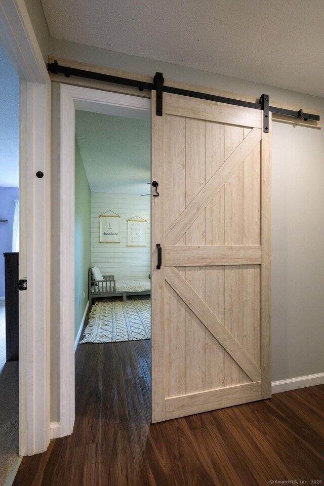 66 Del Prado Dr, Bristol, CT 06010 - hallway with a barn door and dark wood-style floors