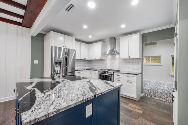16 Pine Rd, Stafford, CT 06076 - kitchen with wall chimney range hood, appliances with stainless steel finishes, tasteful backsplash, light stone countertops, and recessed lighting