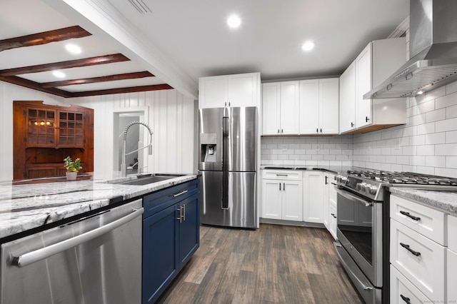 16 Pine Rd, Stafford, CT 06076 - kitchen featuring stainless steel appliances, wall chimney exhaust hood, blue cabinets, tasteful backsplash, and beamed ceiling