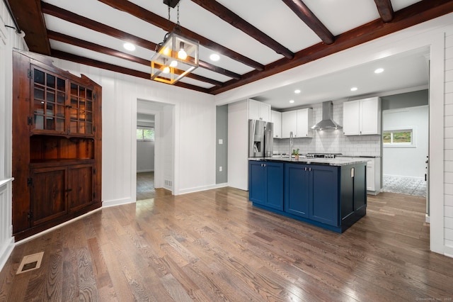 16 Pine Rd, Stafford, CT 06076 - kitchen with wall chimney range hood, blue cabinetry, stainless steel appliances, a chandelier, and white cabinets