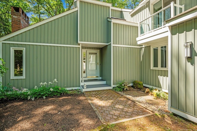 25 Tall Wood Holw, Avon, CT 06001 - property entrance featuring board and batten siding, a chimney, and a balcony