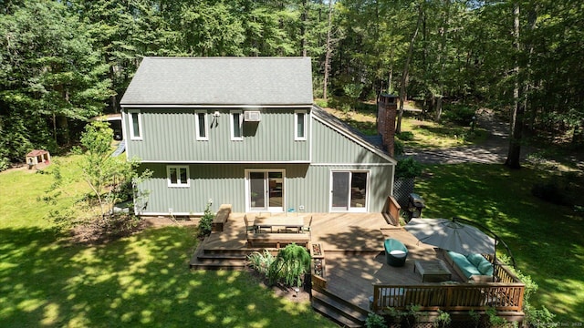 25 Tall Wood Holw, Avon, CT 06001 - back of property with a yard, a deck, a wooded view, a chimney, and a shingled roof