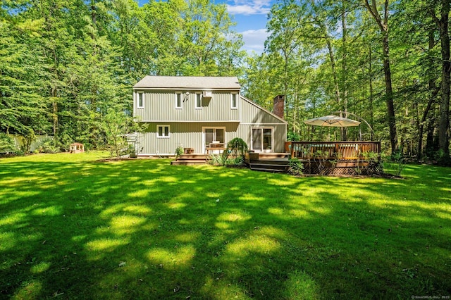 25 Tall Wood Holw, Avon, CT 06001 - back of property featuring a wooden deck, a yard, and a chimney
