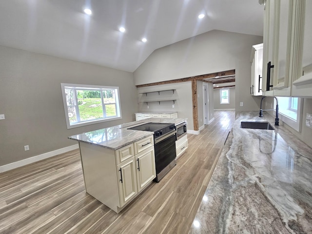 203 Old Jewett City Rd, Preston, CT 06365 - kitchen with appliances with stainless steel finishes, light wood-type flooring, light stone counters, open shelves, and a center island