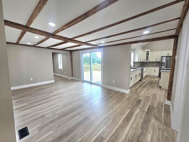 203 Old Jewett City Rd, Preston, CT 06365 - unfurnished living room featuring beamed ceiling, light wood-type flooring, and recessed lighting