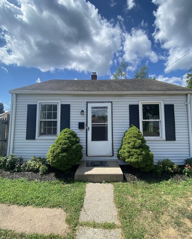 7 Suffolk Dr, East Hartford, CT 06118 - bungalow-style home with a chimney and a shingled roof