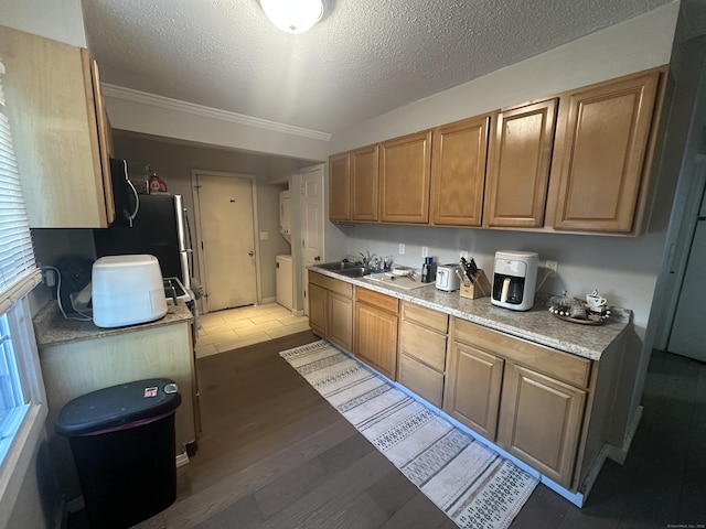 7 Suffolk Dr, East Hartford, CT 06118 - kitchen featuring washer / clothes dryer, light countertops, a textured ceiling, light wood finished floors, and crown molding