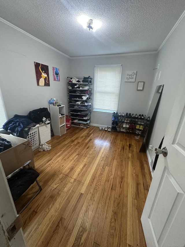 7 Suffolk Dr, East Hartford, CT 06118 - bedroom with crown molding, a textured ceiling, and wood finished floors