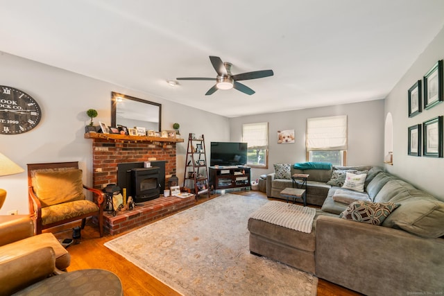 48 Greenwood Cir, Seymour, CT 06483 - living room featuring a wood stove, a ceiling fan, and wood finished floors