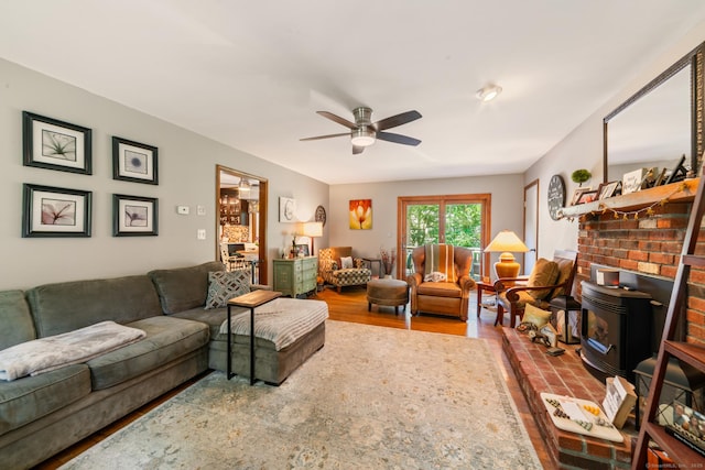 48 Greenwood Cir, Seymour, CT 06483 - living room featuring a wood stove, a ceiling fan, and wood finished floors