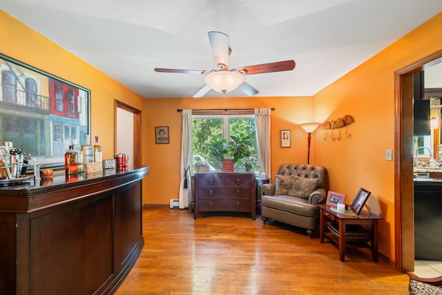 48 Greenwood Cir, Seymour, CT 06483 - living area featuring light wood-type flooring, ceiling fan, and a baseboard heating unit