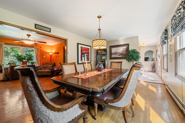 48 Greenwood Cir, Seymour, CT 06483 - dining area featuring a baseboard radiator, light wood finished floors, ceiling fan, and arched walkways