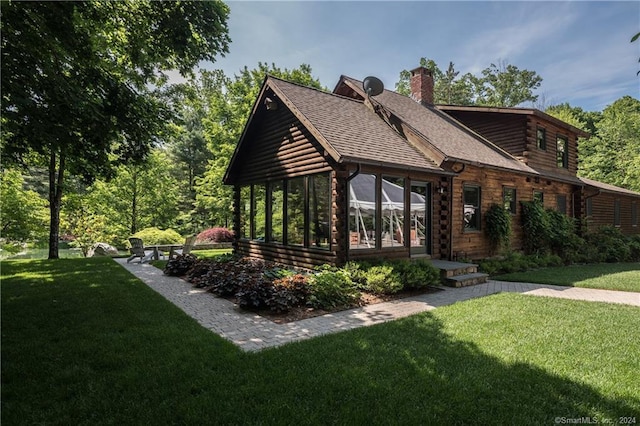 10 Firetower Rd, Killingworth, CT 06419 - view of front of property with a sunroom, a chimney, a front lawn, log siding, and roof with shingles