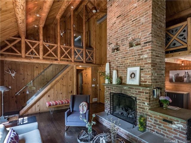 10 Firetower Rd, Killingworth, CT 06419 - unfurnished living room featuring high vaulted ceiling, wood walls, a wood ceiling with exposed beams, hardwood / wood-style flooring, and a fireplace