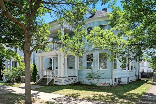 212 Maple St, New Haven, CT 06511 - view of front of home featuring a porch, a chimney, and a front lawn