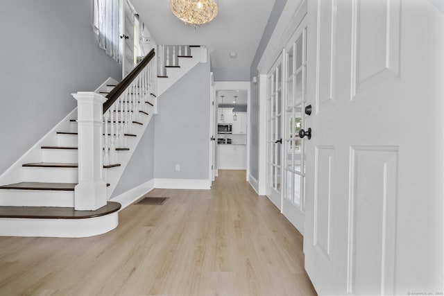 476 Washington Ave, West Haven, CT 06516 - entrance foyer featuring stairway, wood finished floors, and a chandelier