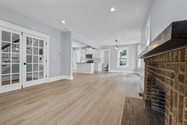 476 Washington Ave, West Haven, CT 06516 - unfurnished living room featuring light wood-style floors, recessed lighting, and a fireplace