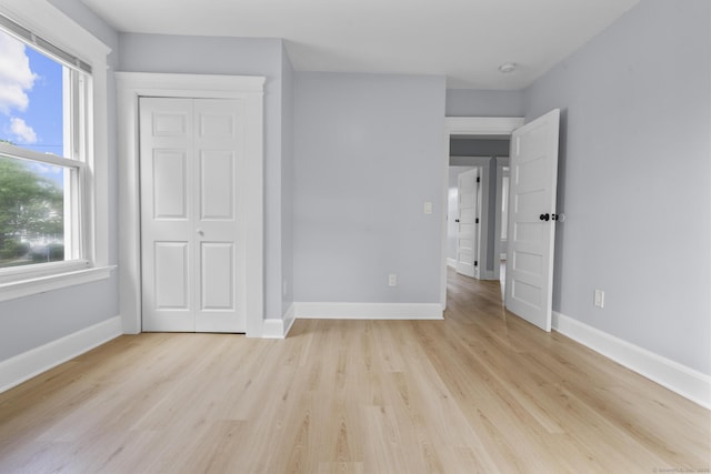 476 Washington Ave, West Haven, CT 06516 - unfurnished bedroom with light wood-style floors and a closet