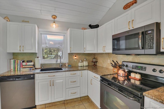 9 Madrina Ln, Madison, CT 06443 - kitchen featuring stainless steel appliances, white cabinets, decorative backsplash, lofted ceiling, and stone counters